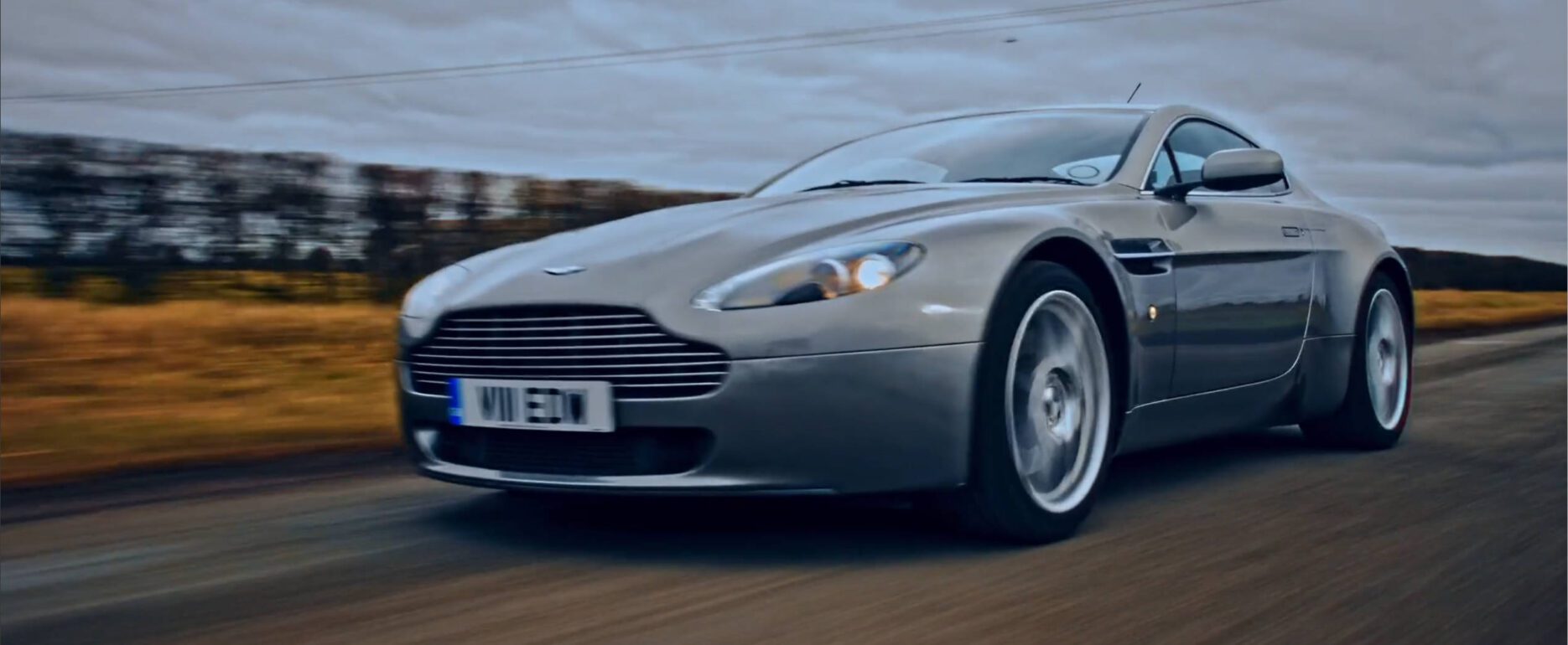 aston martin on road running from front left angle a quatre. – Lumira Studio