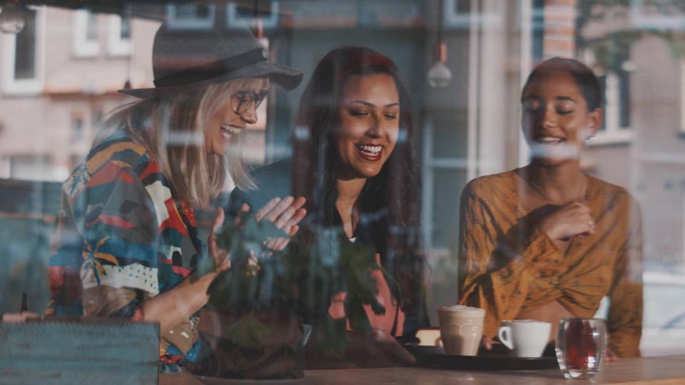 happy and excited women customers enjoying their coffee and cakes in a popular coffee shop | Lumira Studio Video Production Hertfordshire