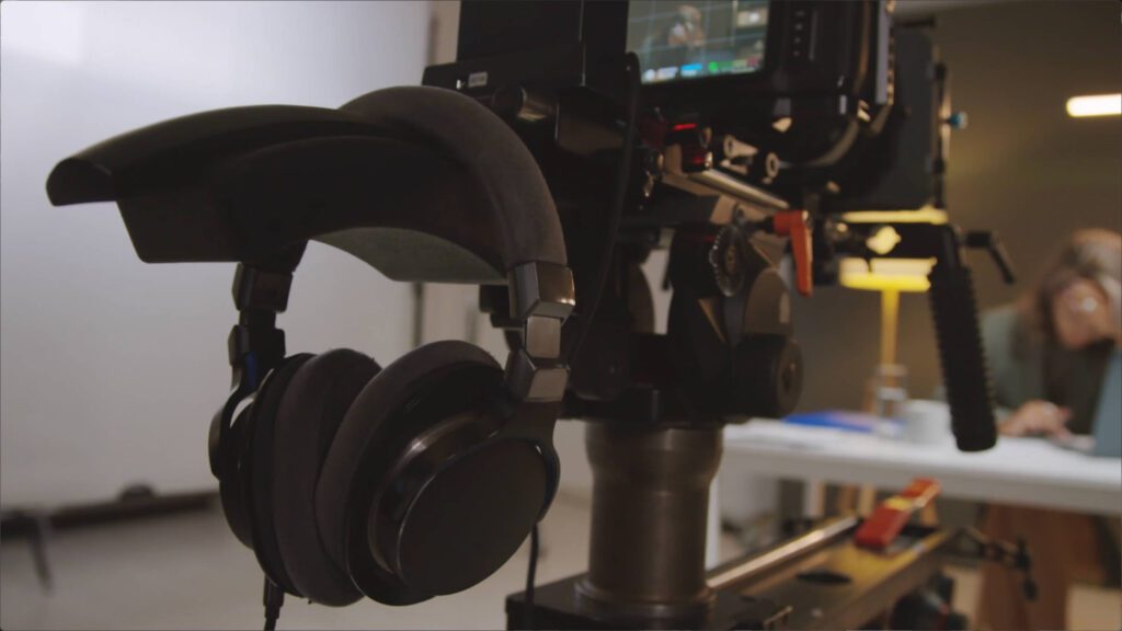 headphones resting on film camera on set | Lumira Studio Video Production Hertfordshire