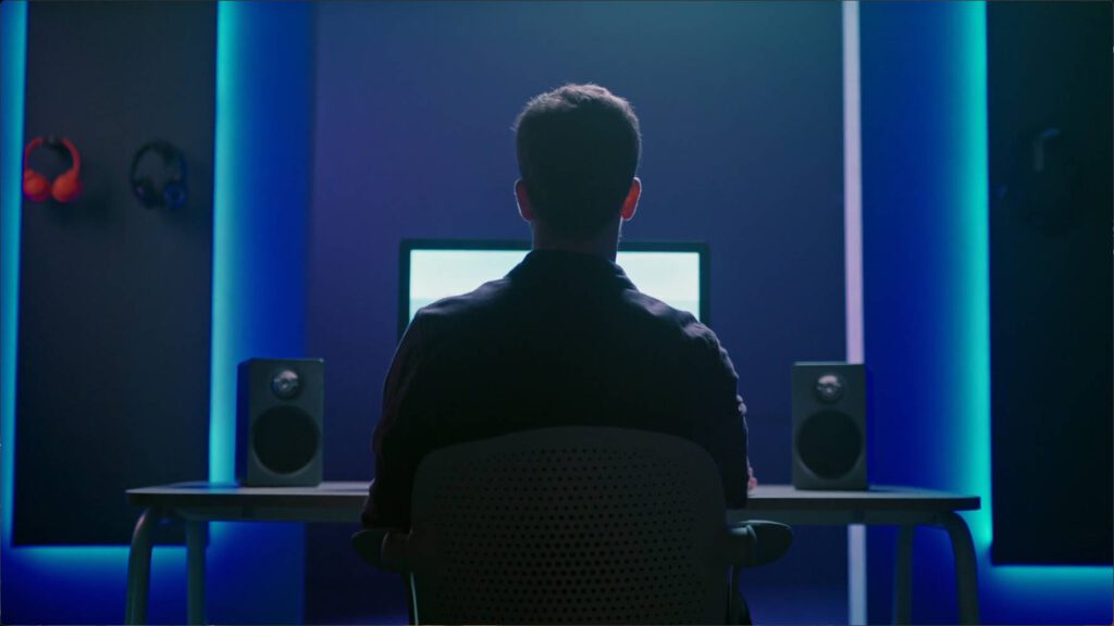 day 6 post-production_a man sit in front of computer monitor doing video post production – Lumira Studio