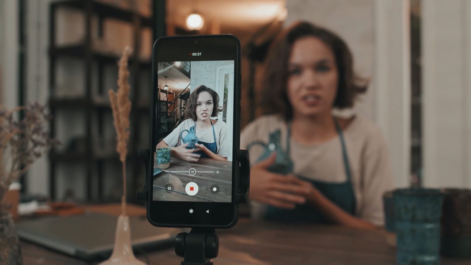 a woman filming herself on a smart phone_Micro-Moments: Harnessing the Art of Snackable Videos for Maximum Engagement | Lumira Studio Video Production Hertfordshire