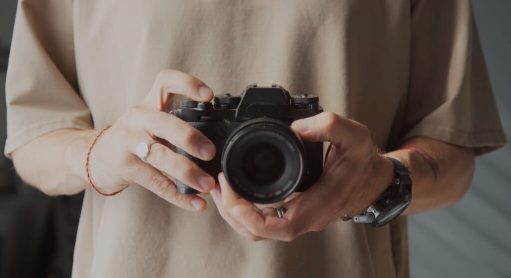 a photographer holding a camera in hand